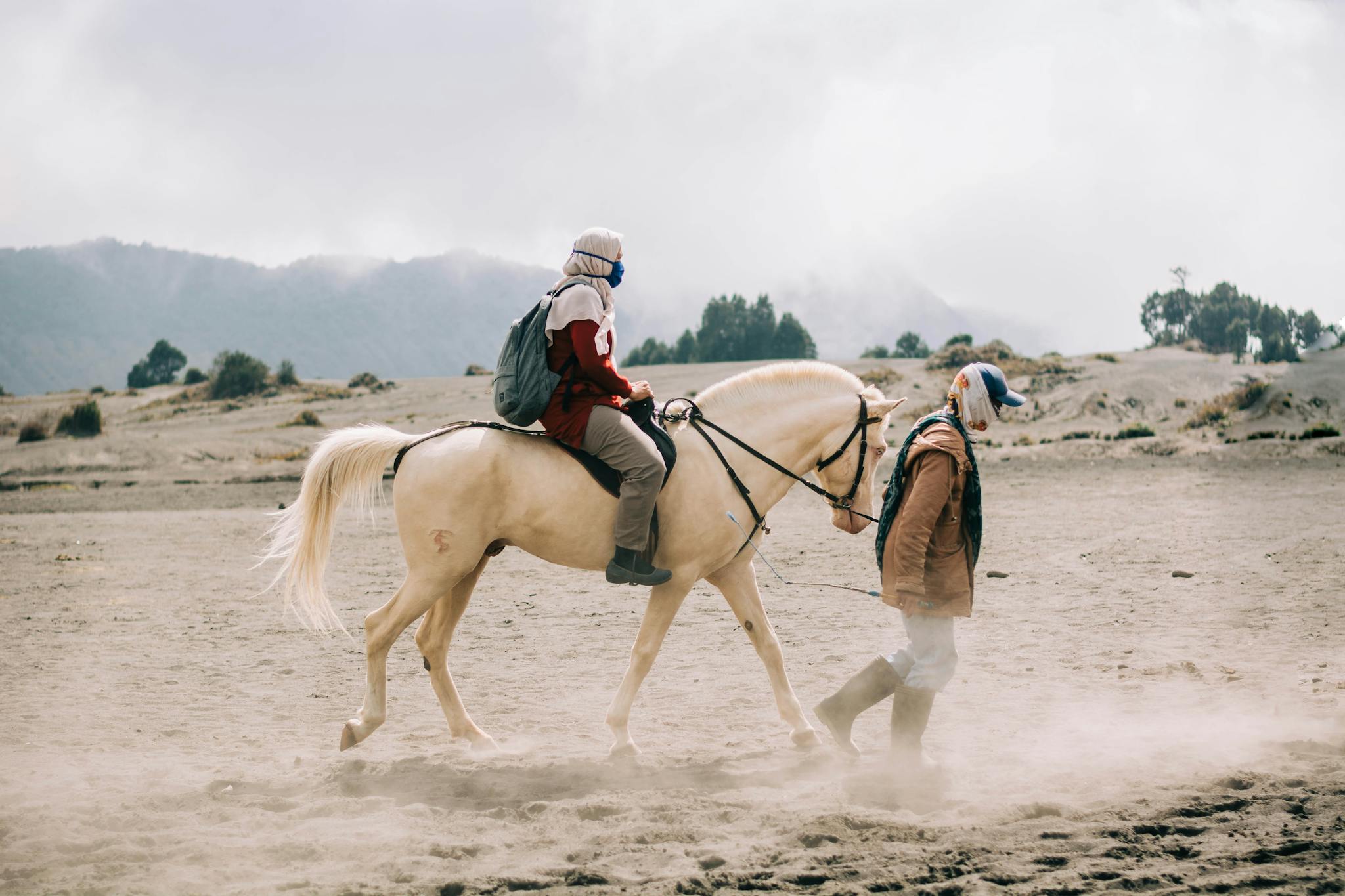 Horseback riding in the sandy terrain of East Java, Indonesia, capturing local culture and stunning landscapes.