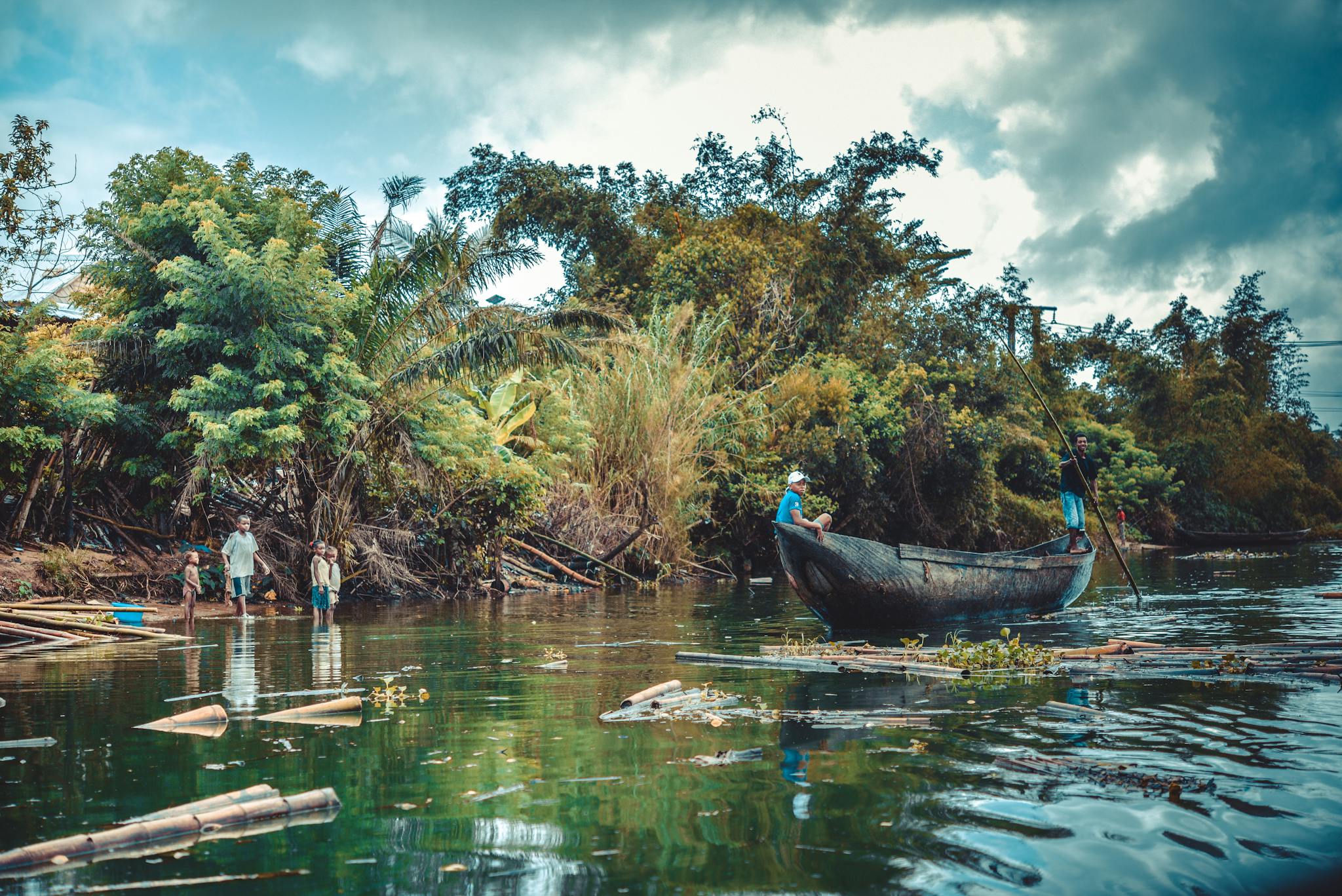 Scenic view of people boating on a lush river surrounded by vibrant greenery in Madagascar.