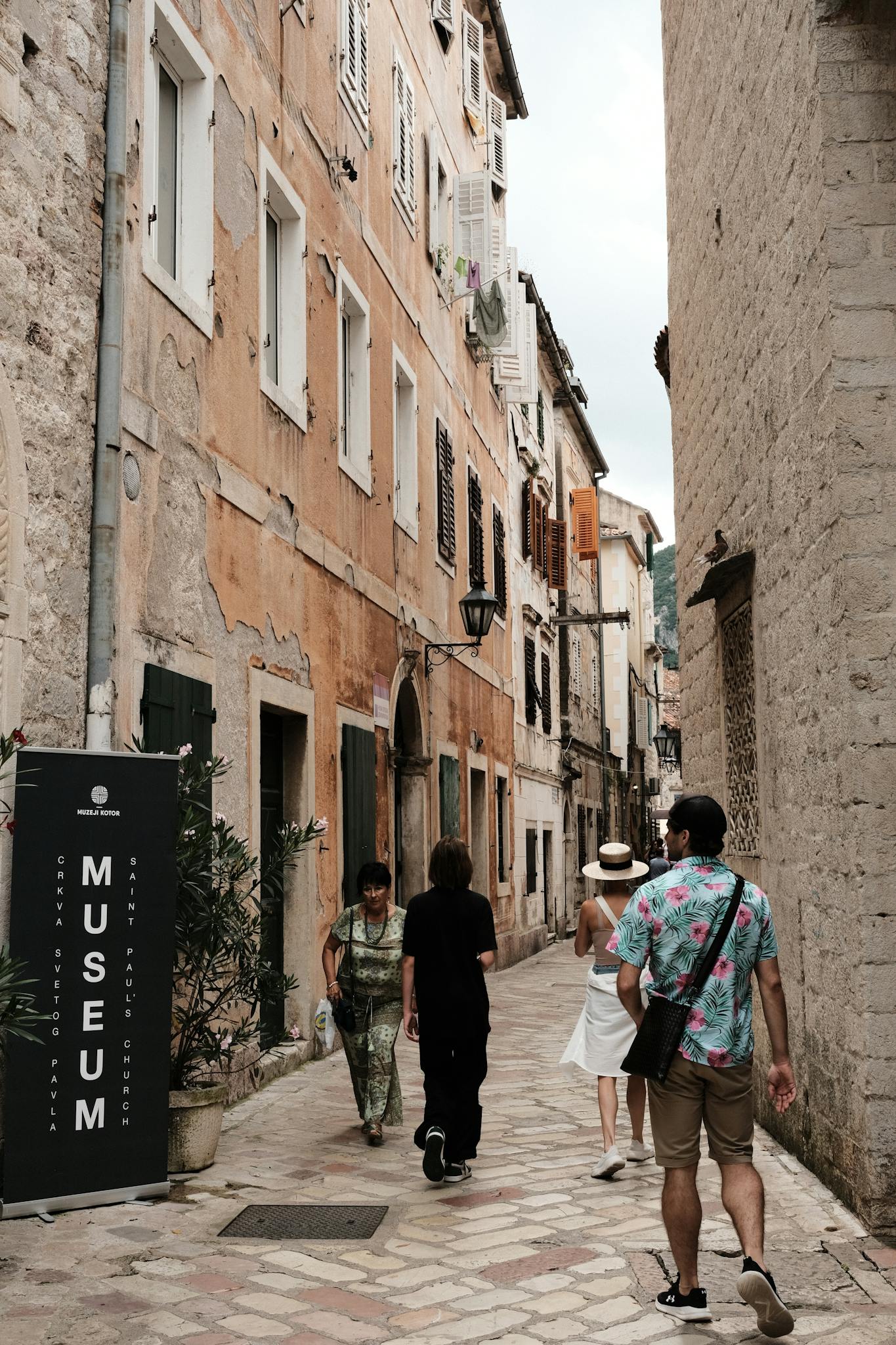 Tourists roam the charming cobblestone streets of Kotor's old town.